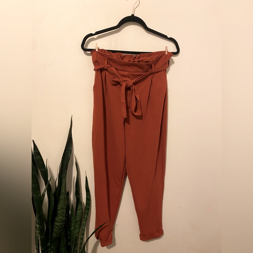 Dark burnt orange tie around pants